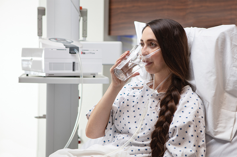 patient connected to Masimo softFlow while drinking water