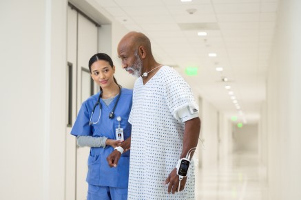 Patient walking through facility with VSM on wrist